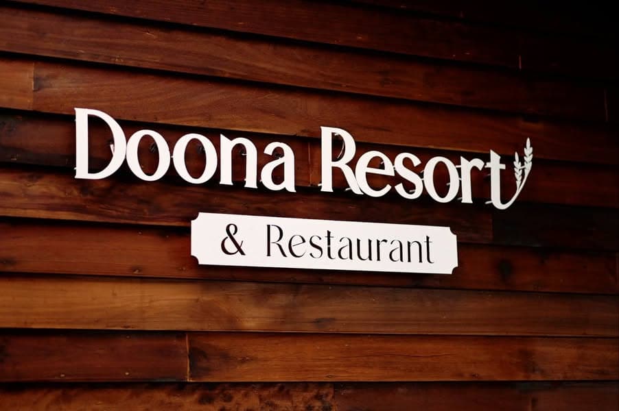 Doona Resort and Restaurant wordmark mounted on local teak